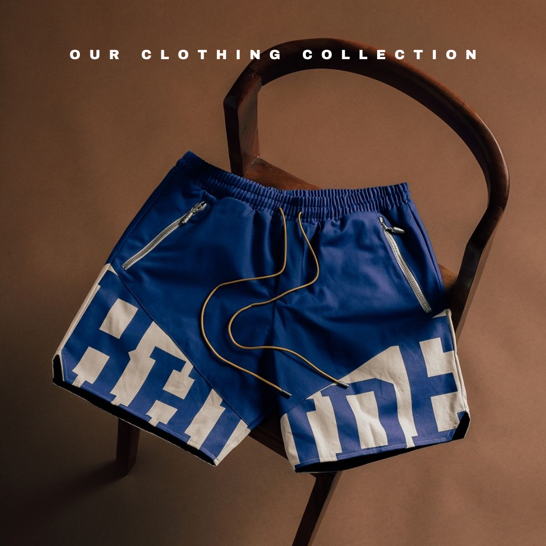 Blue graphic shorts with drawstrings on a wooden chair, clothing collection display