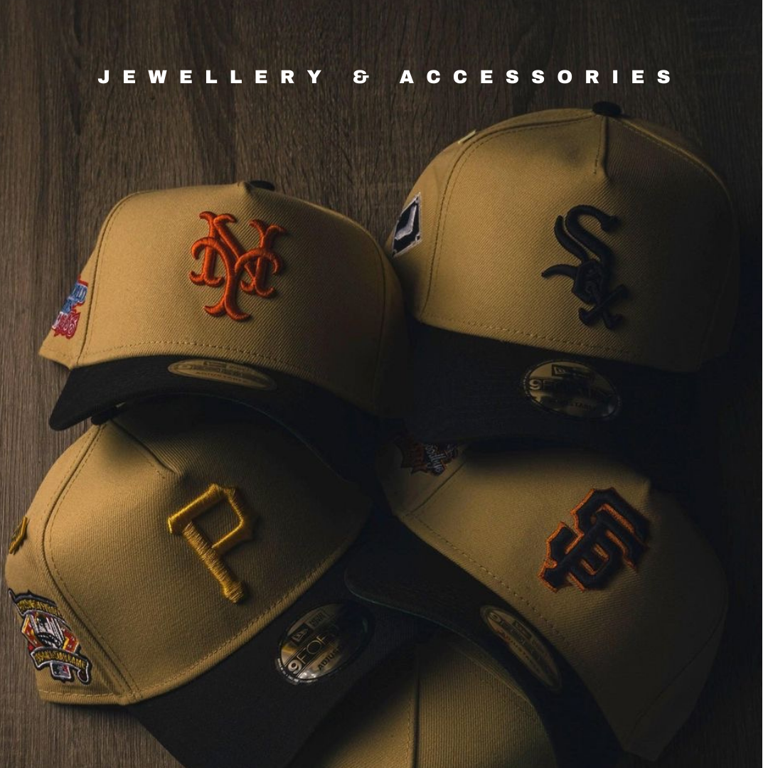 Beige and black baseball caps with MLB team logos on dark wood surface, New Era hats